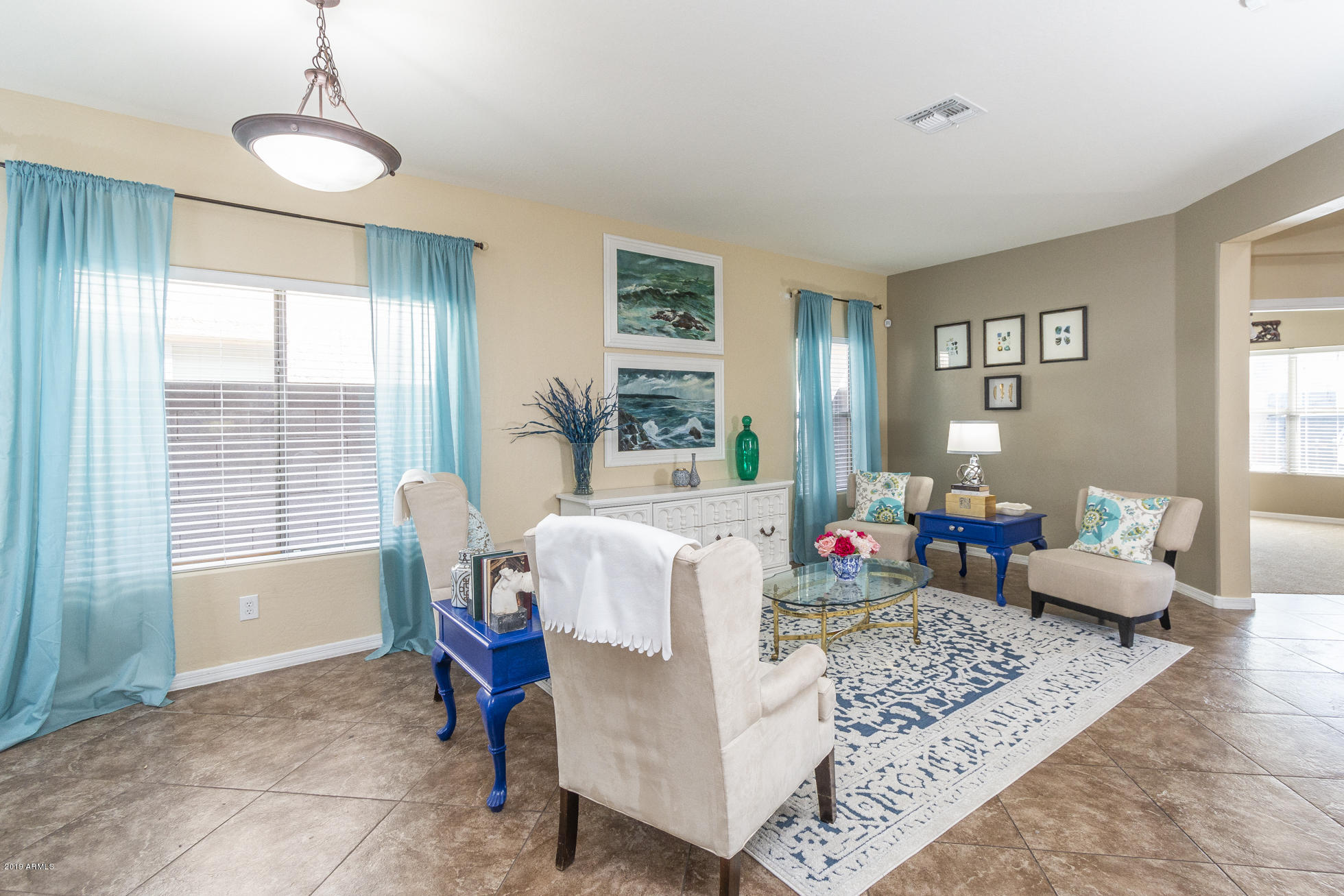 16770 West Rowel Road Surprise, AZ 85387 - Photo 4 of 34 a living room with furniture and wooden floor