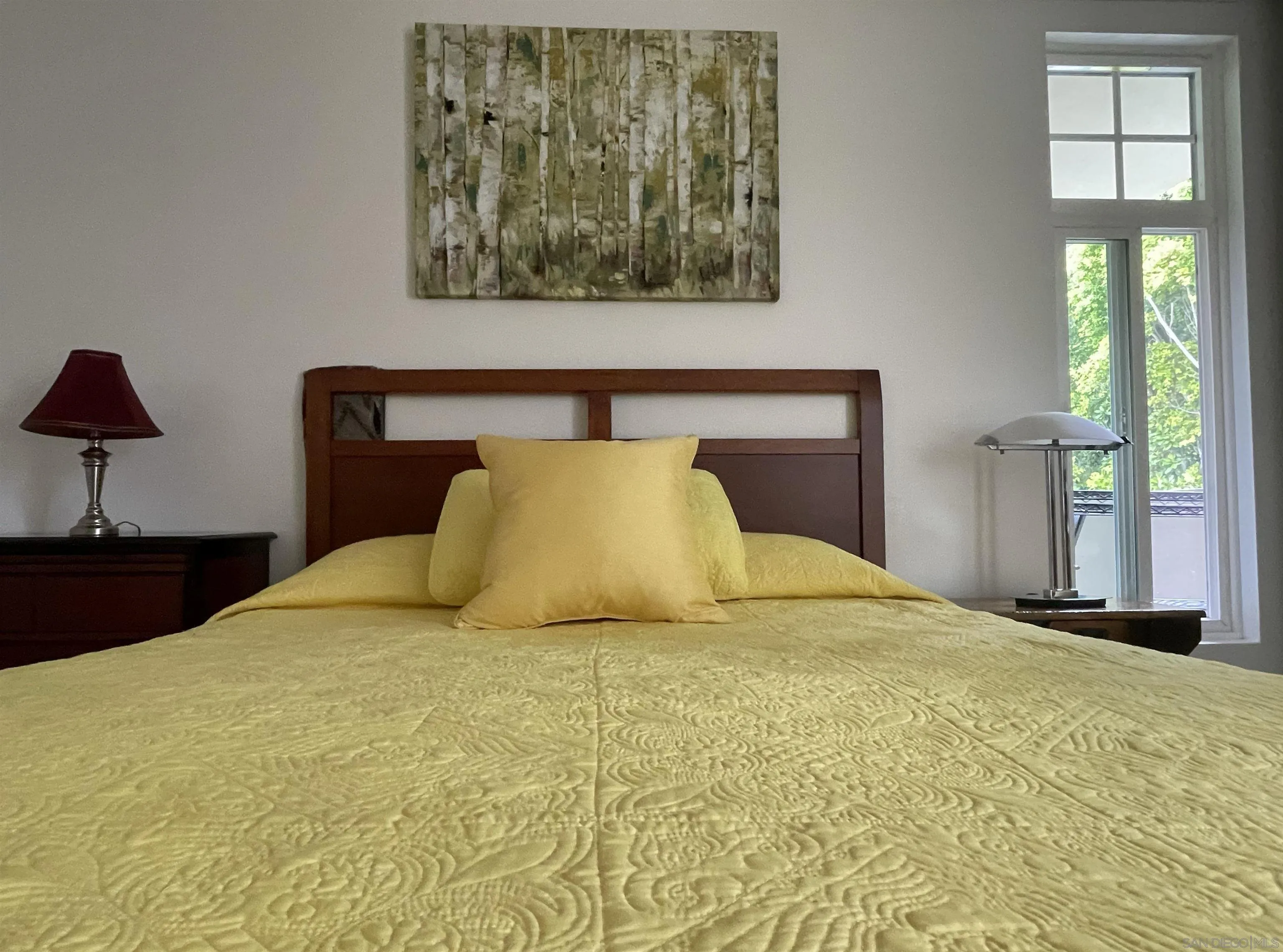 2510 Torrey Pines Road, Unit 413 La Jolla, CA 92037 - Photo 12 of 15 a large bed sitting in a bedroom next to a window