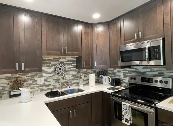 a kitchen with stainless steel appliances a stove sink and cabinets