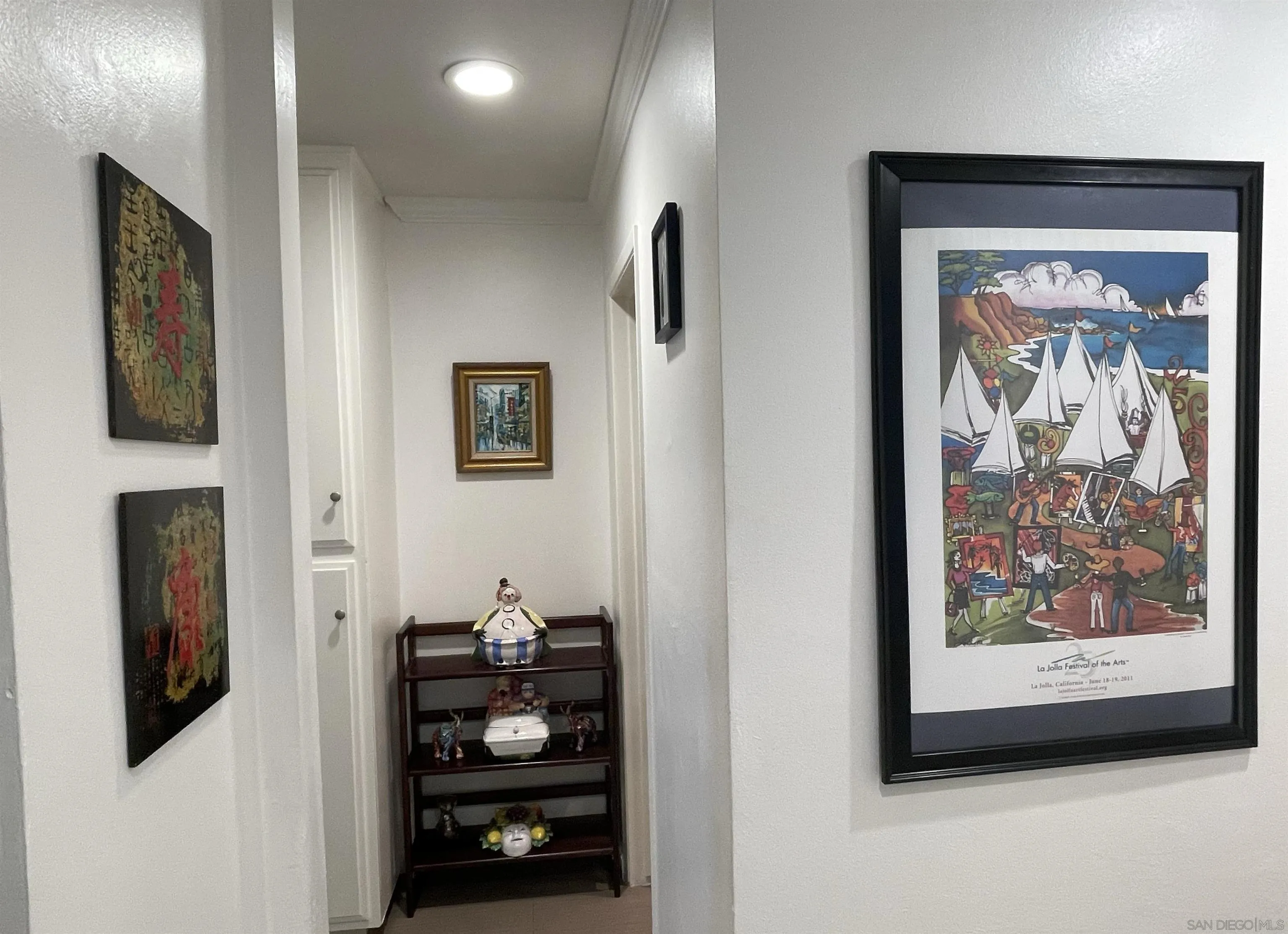 2510 Torrey Pines Road, Unit 413 La Jolla, CA 92037 - Photo 8 of 15 a room with painting on the wall and a painting on the wall