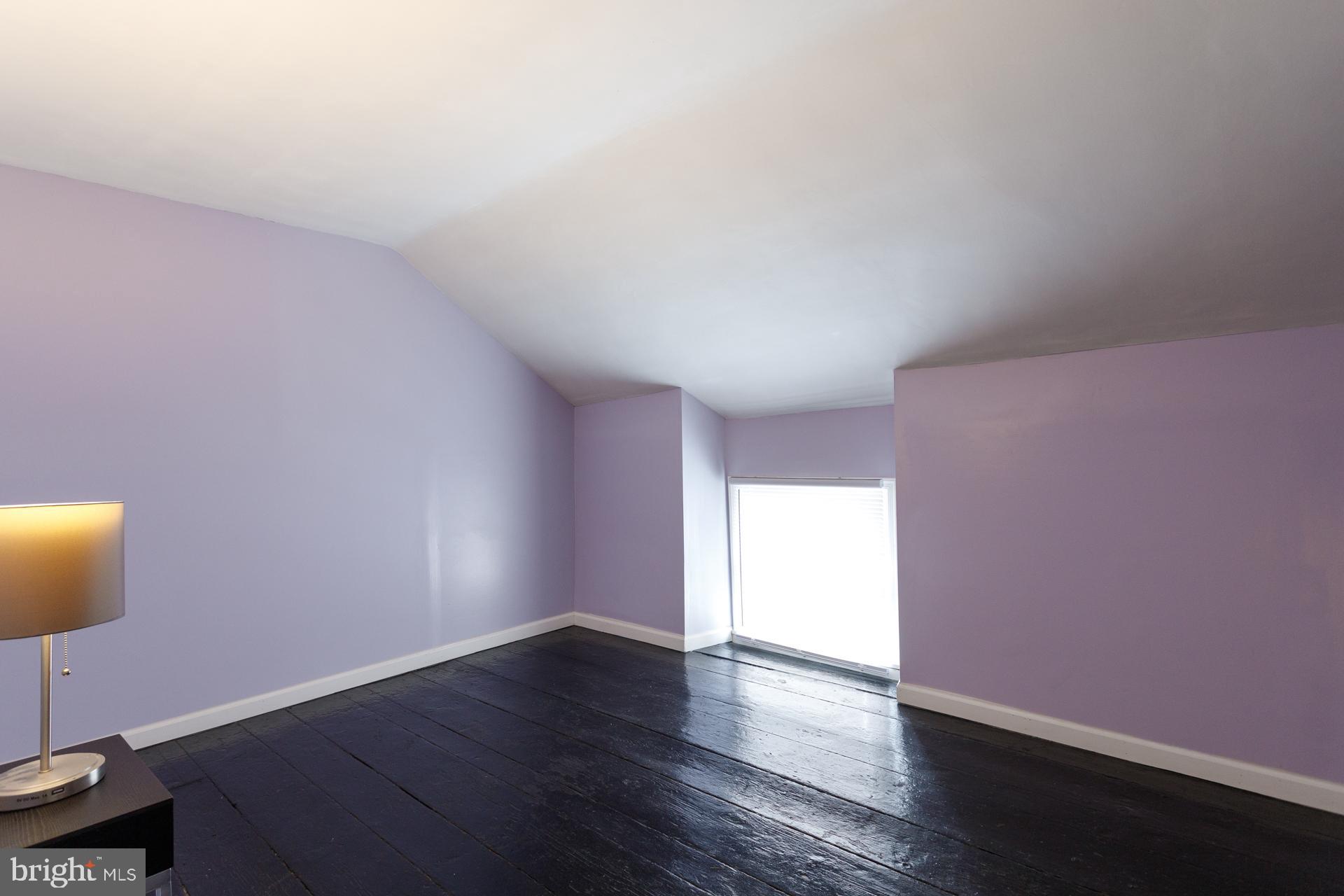 108 Roxborough Avenue Philadelphia, PA 19127 - Photo 19 of 21 a view of an empty room with wooden floor and a window