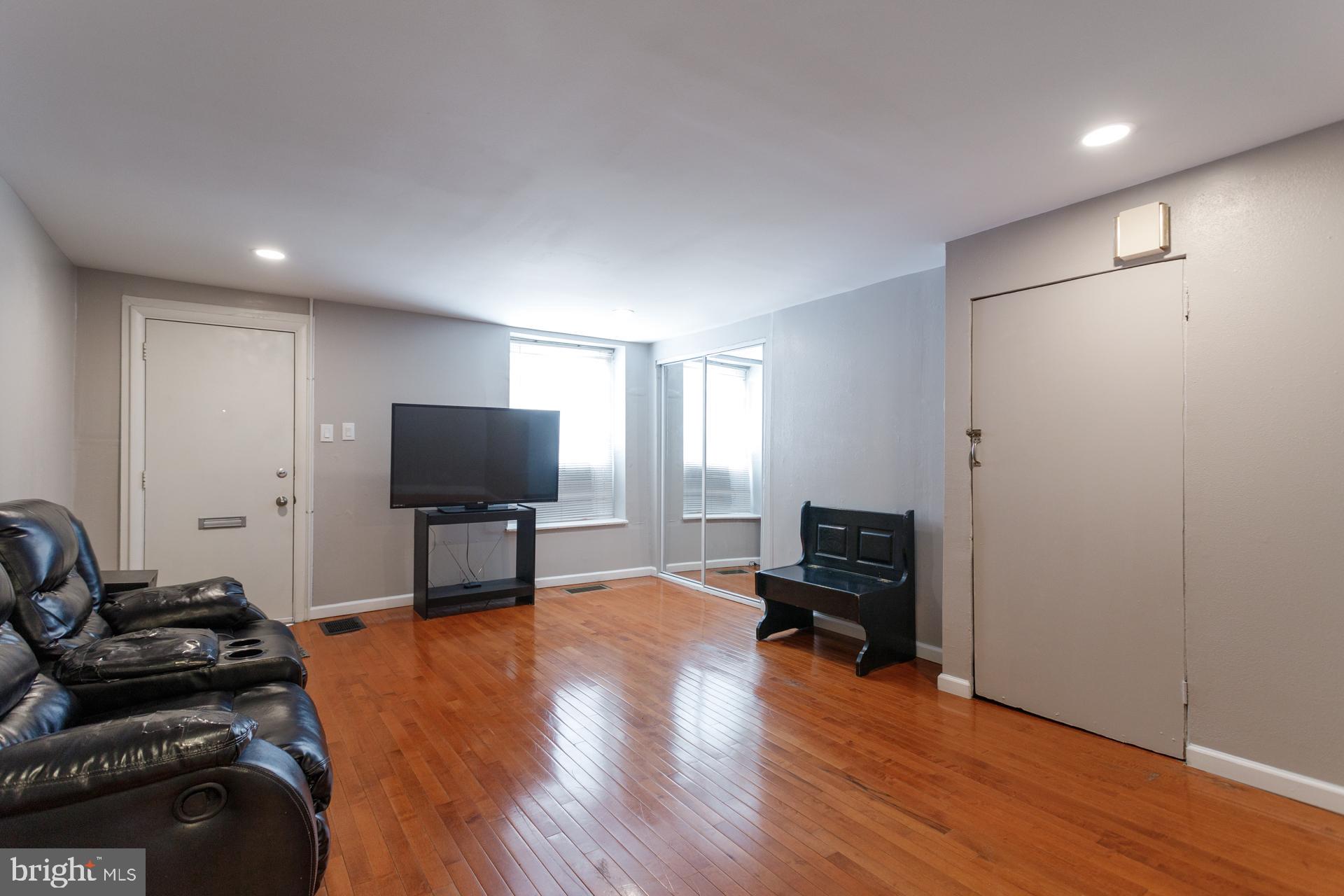 108 Roxborough Avenue Philadelphia, PA 19127 - Photo 2 of 21 a living room with furniture and a flat screen tv