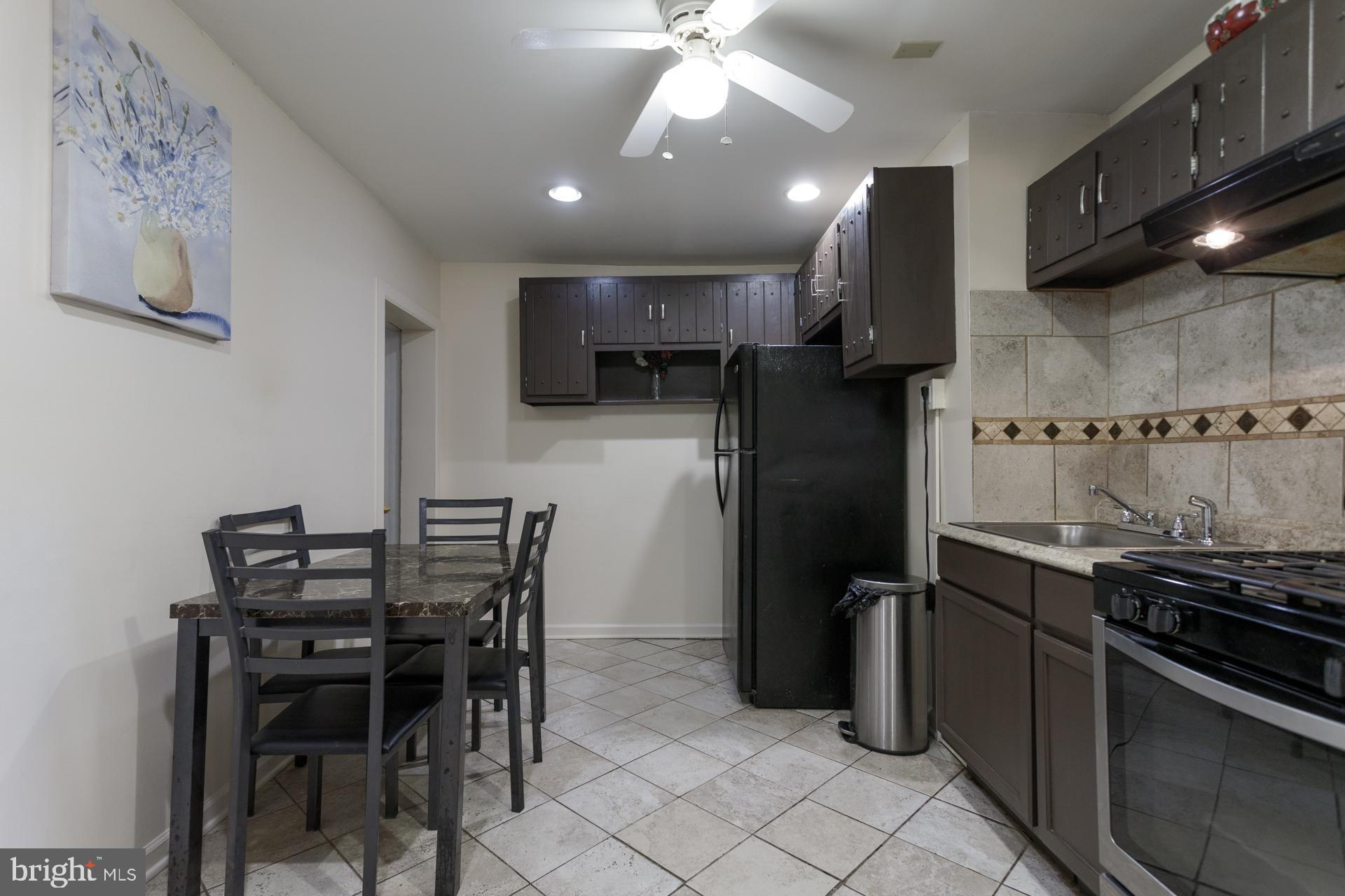 108 Roxborough Avenue Philadelphia, PA 19127 - Photo 6 of 21 a kitchen with a table and chairs