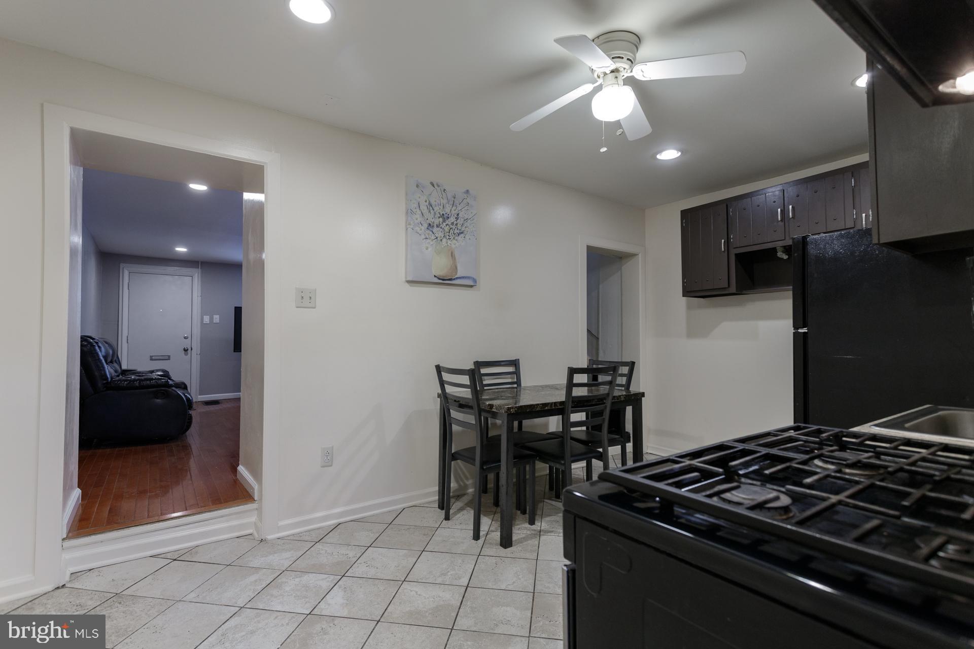 108 Roxborough Avenue Philadelphia, PA 19127 - Photo 7 of 21 a kitchen with granite countertop a stove and a refrigerator