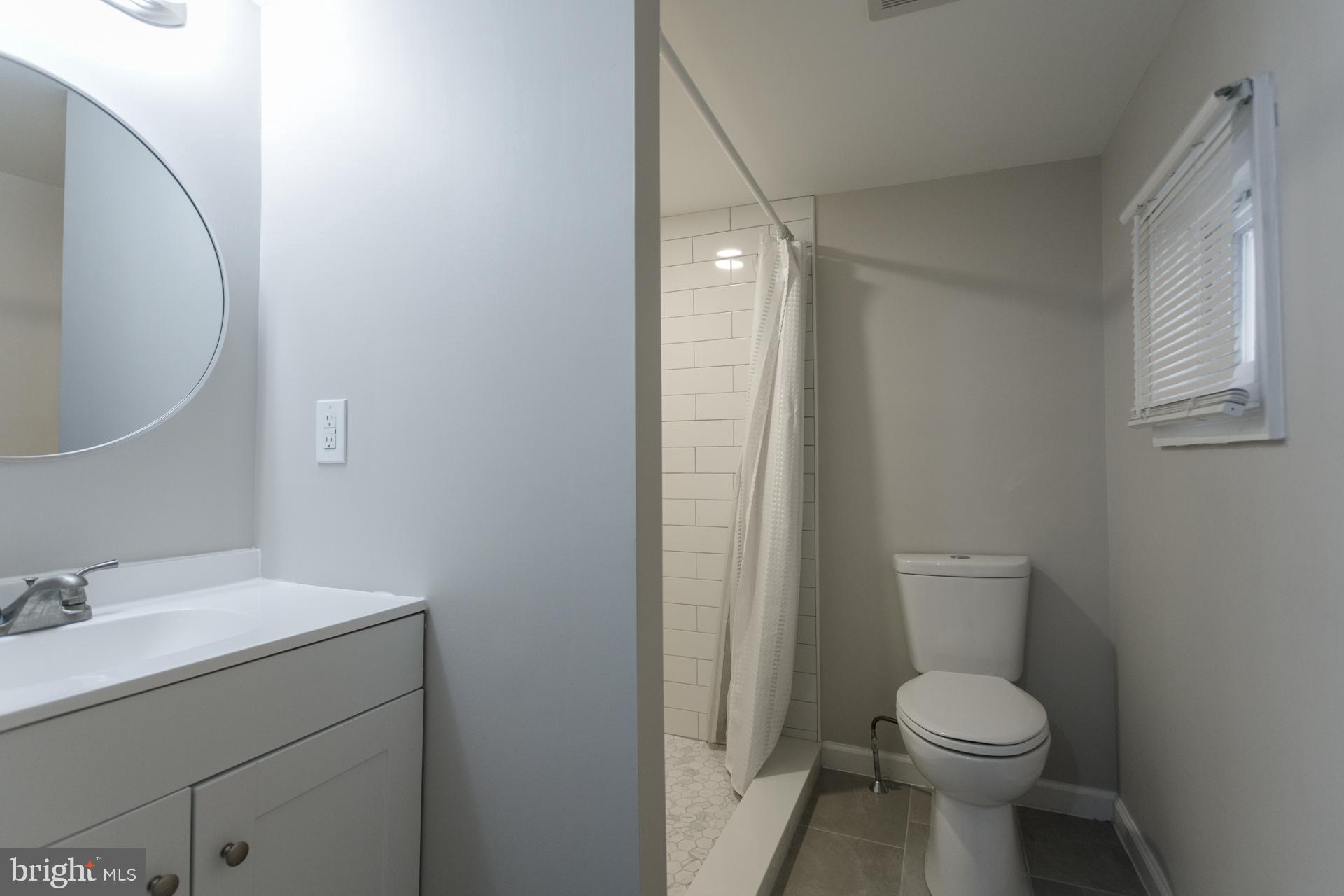 108 Roxborough Avenue Philadelphia, PA 19127 - Photo 10 of 21 a bathroom with a toilet sink and mirror