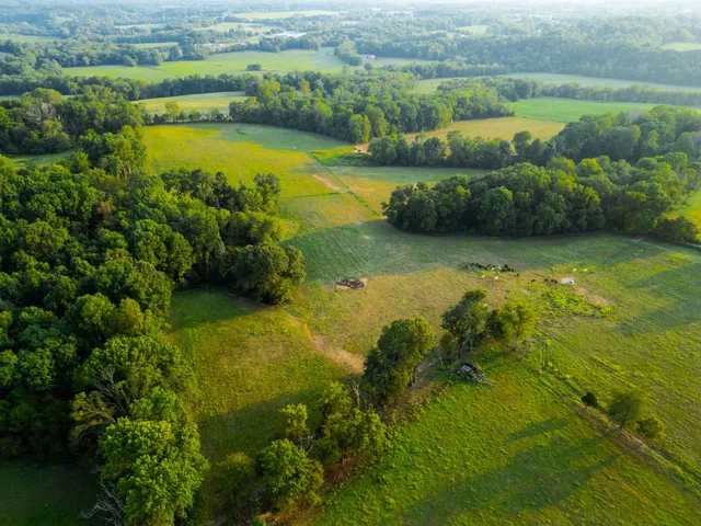 a view of an ocean a building in the background