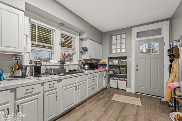 a kitchen with cabinets and window