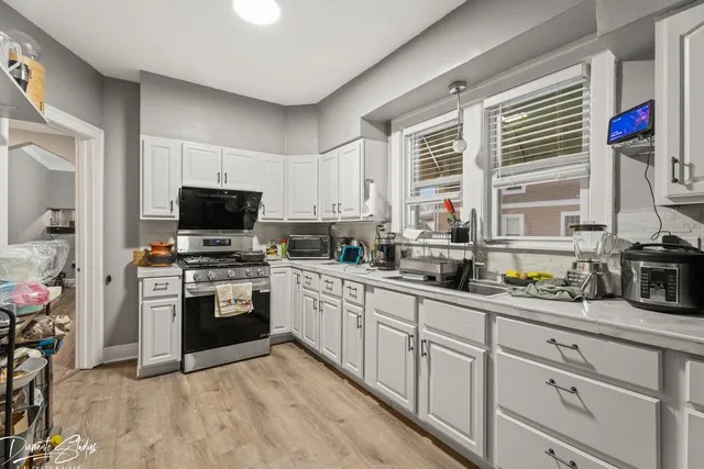 a kitchen with granite countertop a sink stainless steel appliances and cabinets