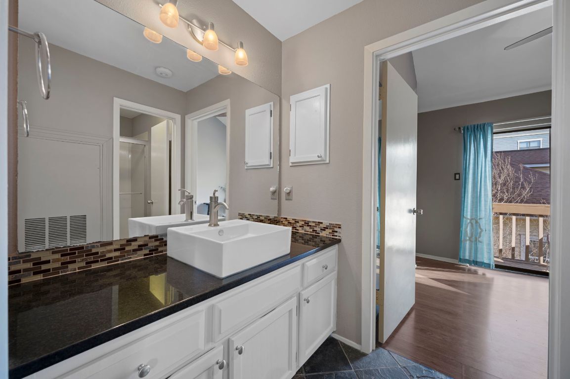 2210 Pearl Street, Unit 301 Austin, TX 78705 - Photo 14 of 35 a bathroom with a sink double vanity and a mirror