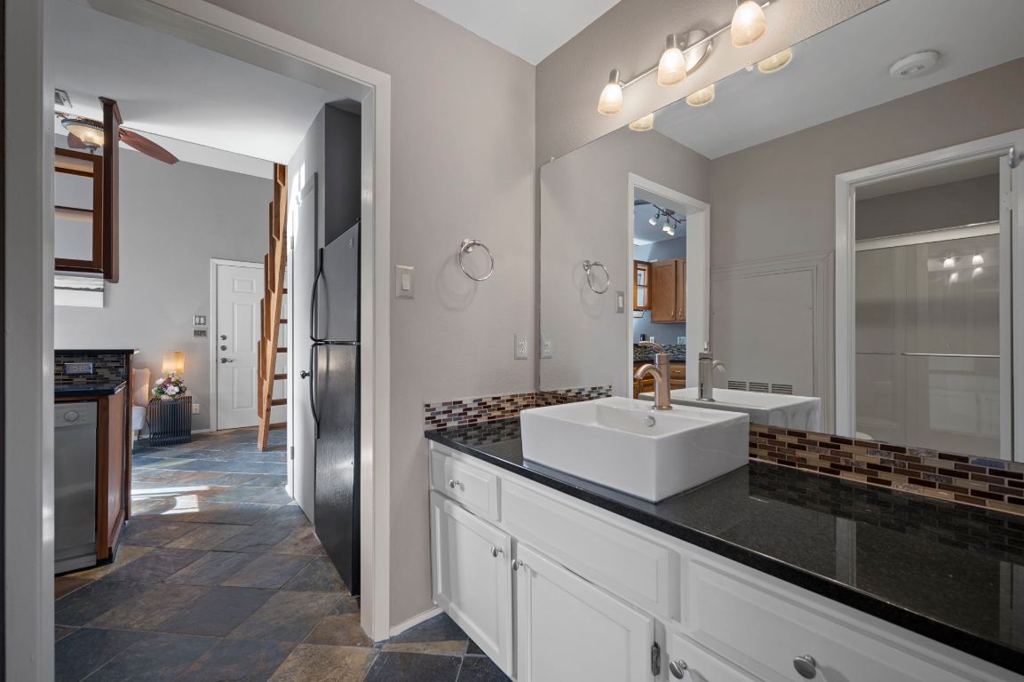 2210 Pearl Street, Unit 301 Austin, TX 78705 - Photo 18 of 35 a spacious bathroom with a sink and a mirror