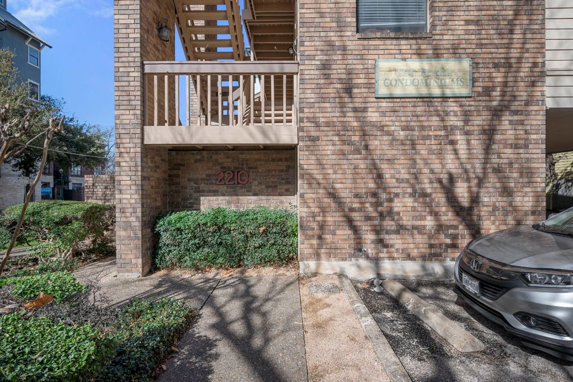 2210 Pearl Street, Unit 301 Austin, TX 78705 - Photo 22 of 35 a brick building with a small yard