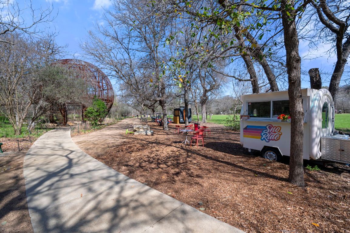 2210 Pearl Street, Unit 301 Austin, TX 78705 - Photo 31 of 35 a backyard of a house with barbeque oven table and chairs
