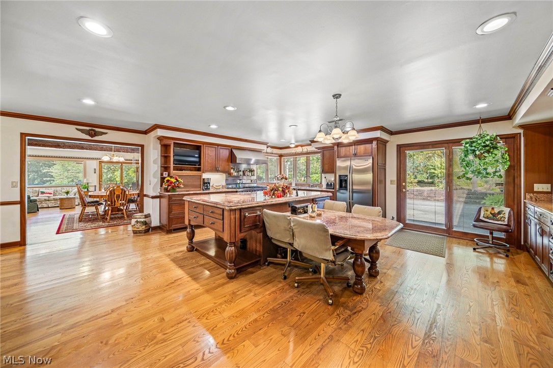 8801 Bunker Road Orwell, OH 44076 - Photo 19 of 50 Dining space featuring a chandelier, crown molding, light wood-style floors, healthy amount of natural light, and recessed lighting