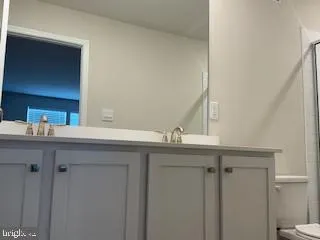 a bathroom with a glass shower door