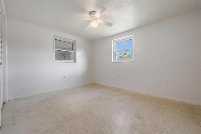 a view of an empty room with a ceiling fan