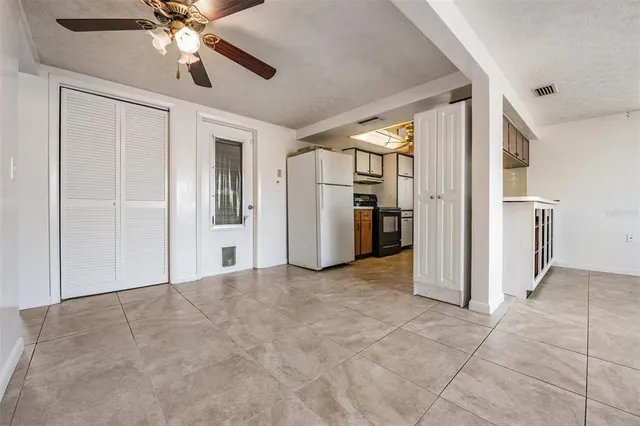 a view of kitchen with refrigerator and microwave