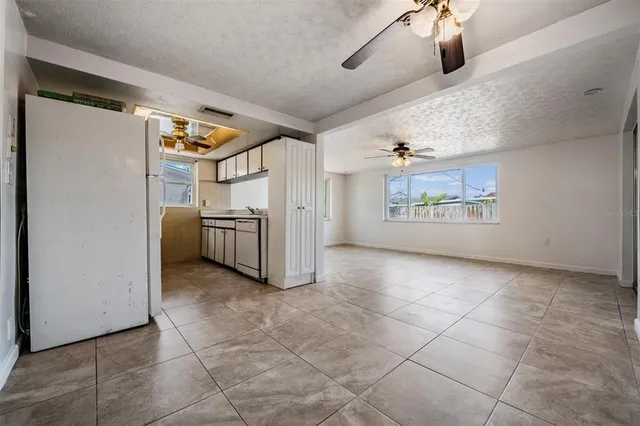 a view of a room with a ceiling fan