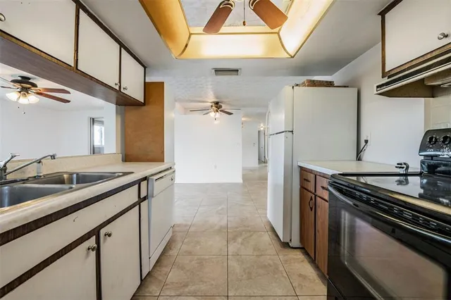 a kitchen with a refrigerator and a sink