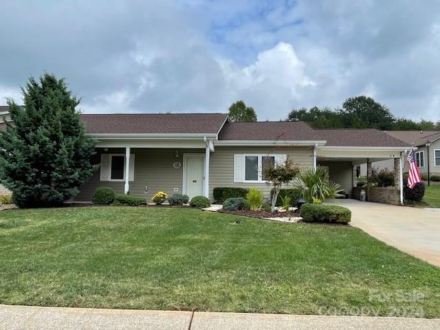a front view of a house with a garden and yard
