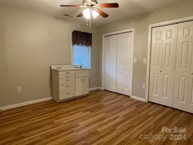 505 2nd St Place Northeast, Unit E4 Conover, NC 28613 - Photo 9 of 17 an empty room with wooden floor closet and windows