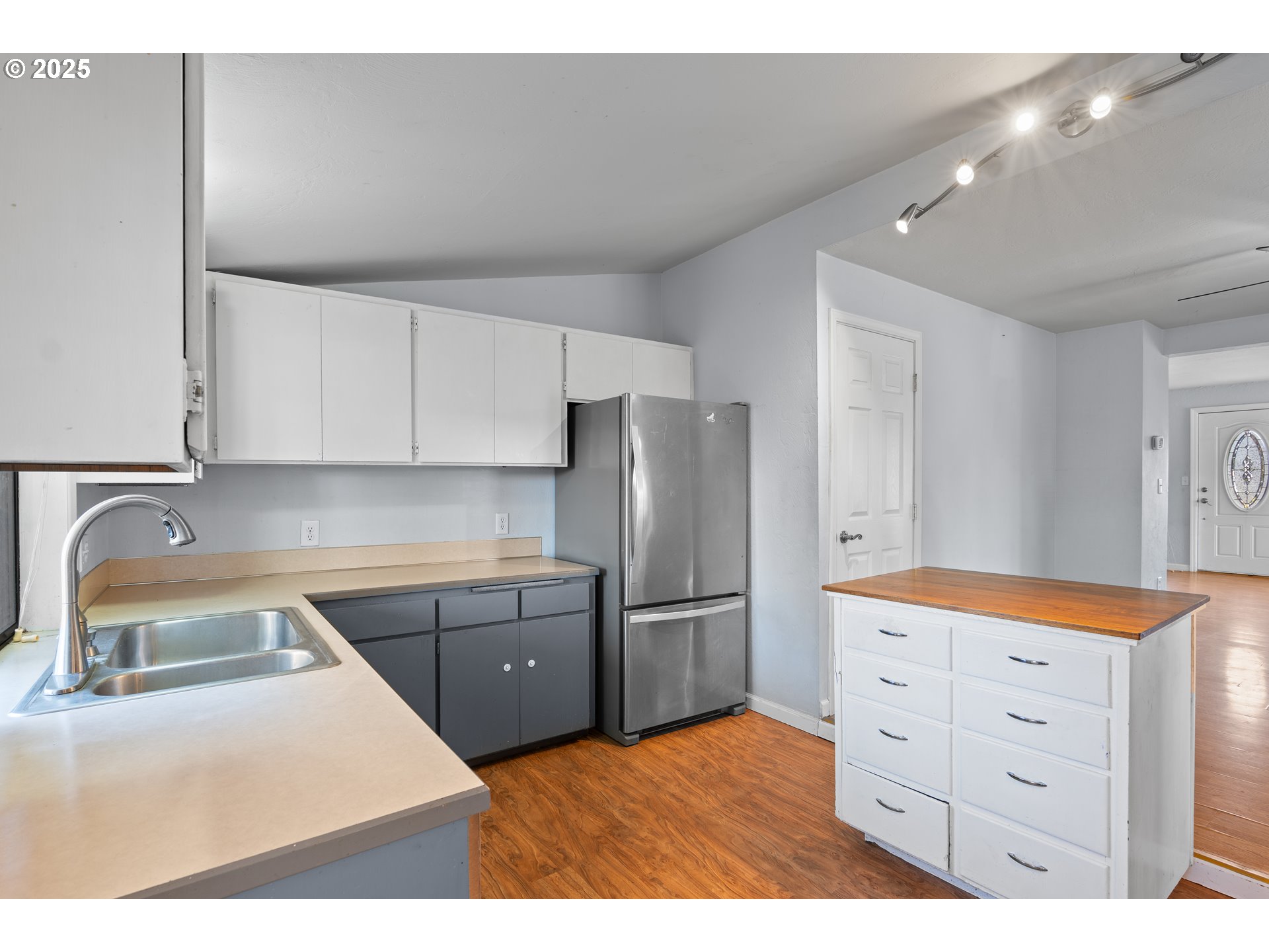 1021 Deal Street Junction City, OR 97448 - Photo 14 of 43 a kitchen with white cabinets and stainless steel appliances
