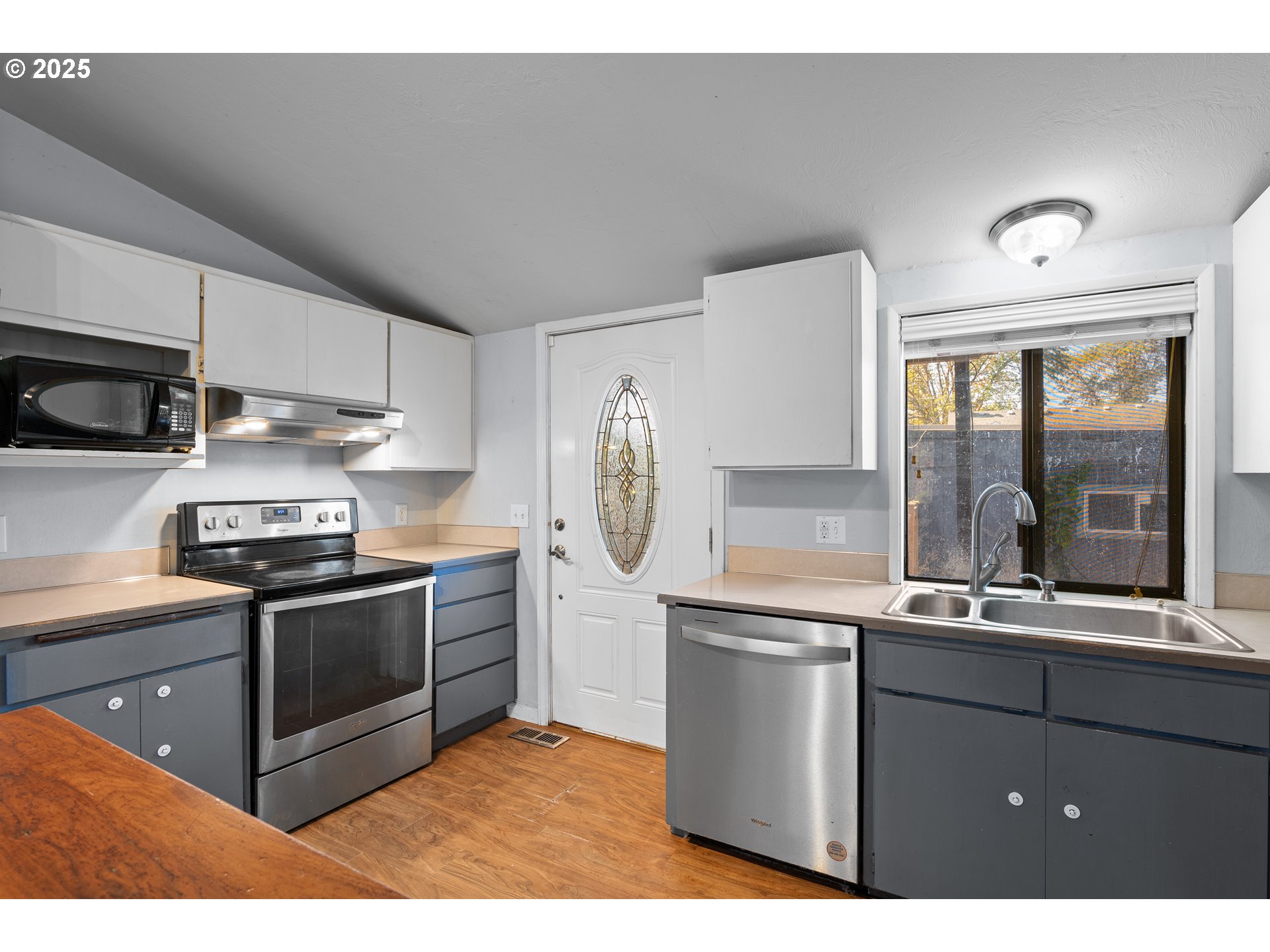 1021 Deal Street Junction City, OR 97448 - Photo 15 of 43 a kitchen with stainless steel appliances granite countertop a stove a sink and a refrigerator