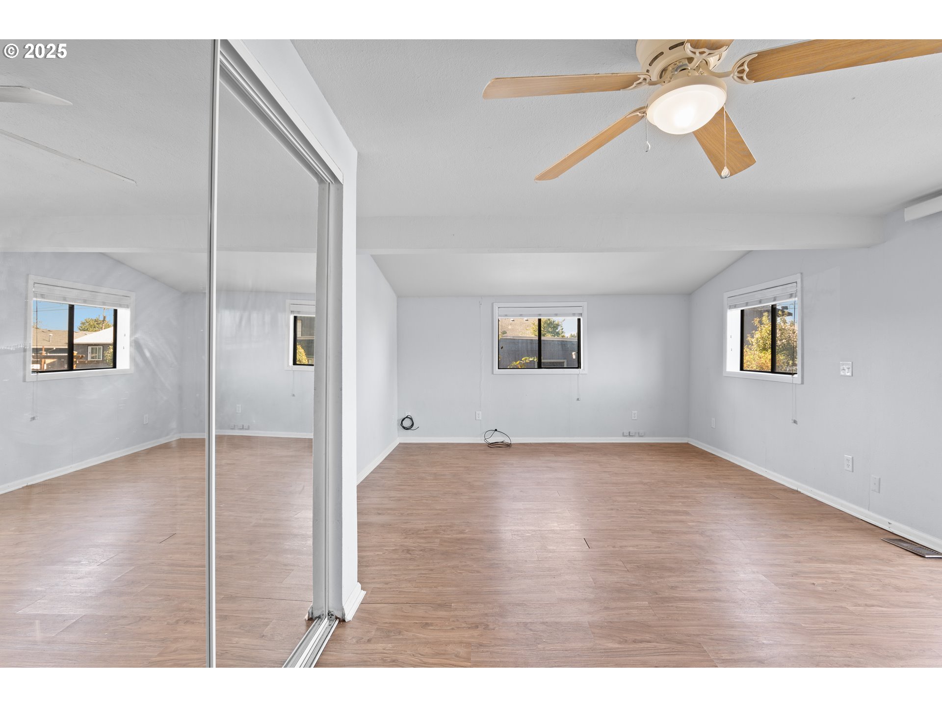 1021 Deal Street Junction City, OR 97448 - Photo 17 of 43 a view of an empty room with wooden floor and a window