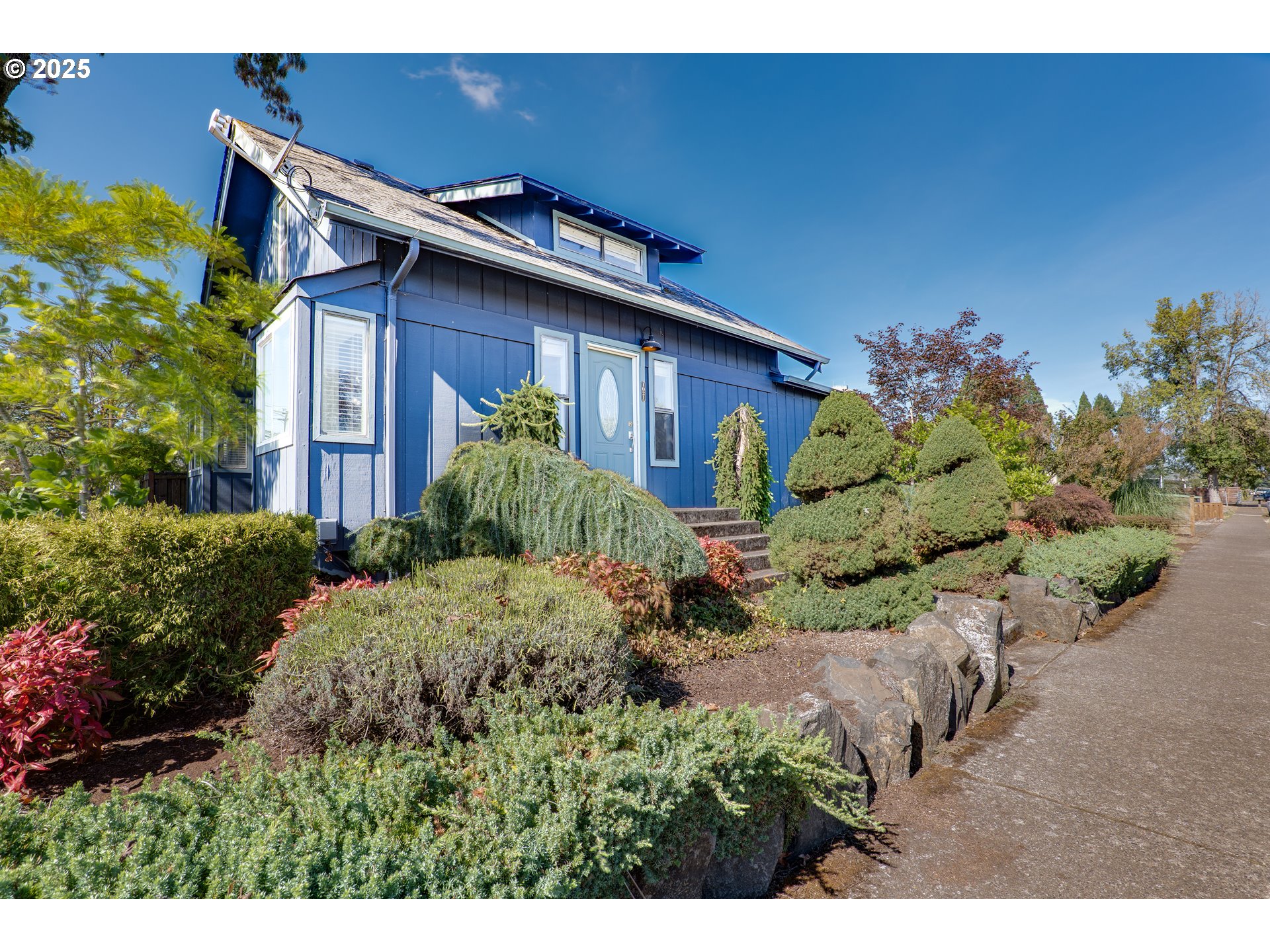 1021 Deal Street Junction City, OR 97448 - Photo 5 of 43 a view of a house with a flower garden