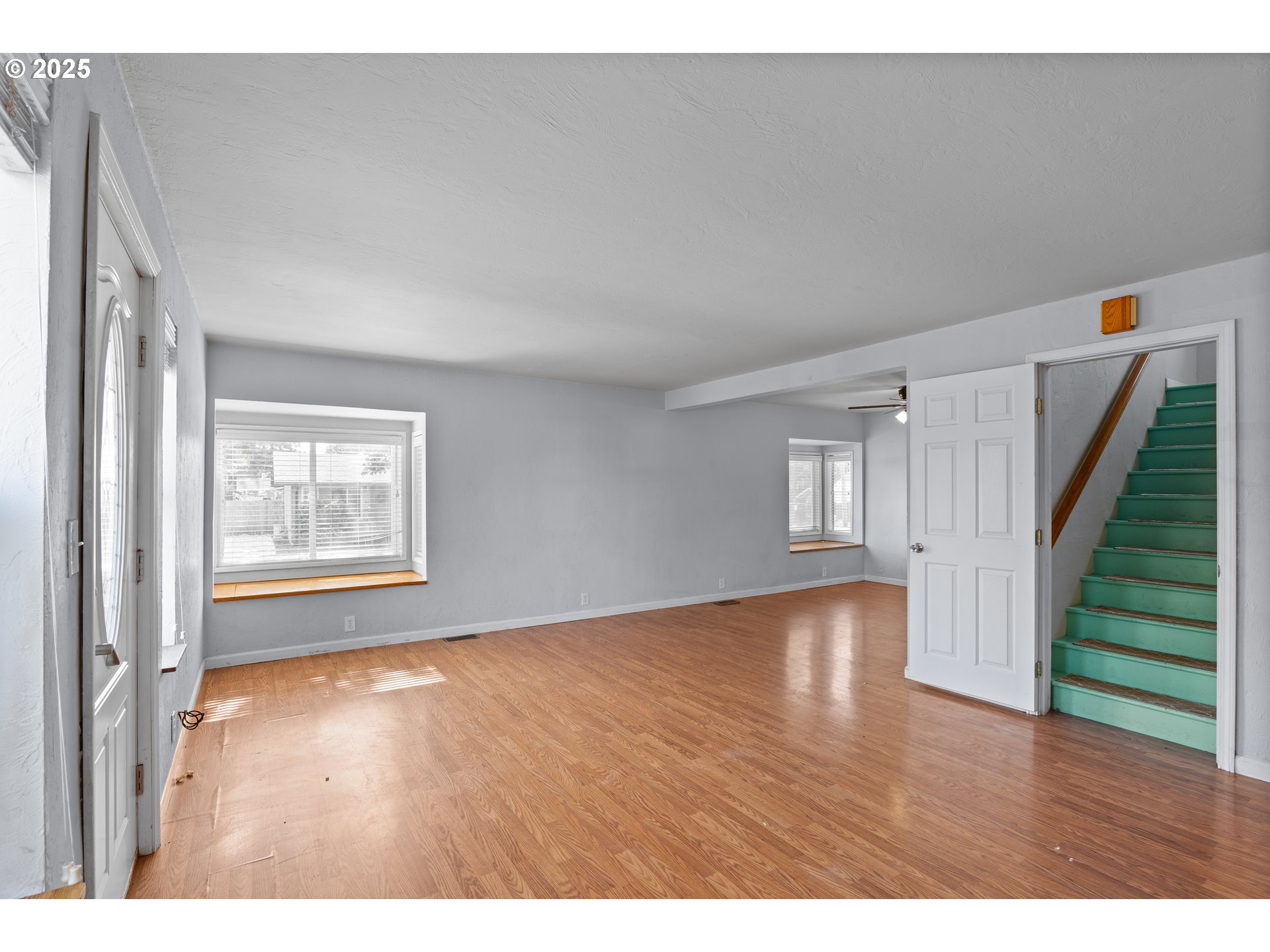 1021 Deal Street Junction City, OR 97448 - Photo 10 of 43 a view of an empty room with wooden floor and stairs