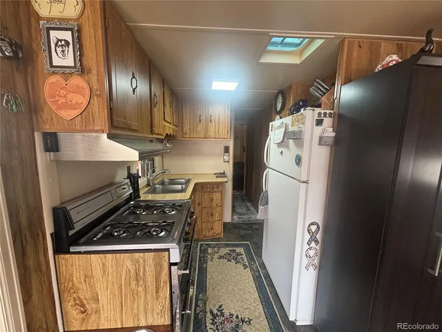 a stove top oven sitting inside of a kitchen