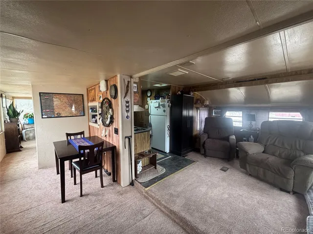 a view of a hallway with workspace and a window