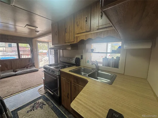 a view of a hallway with furniture and floor to ceiling window