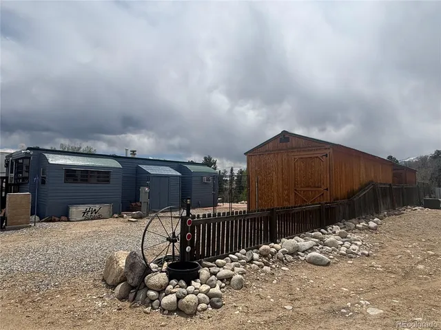 a view of a backyard with wooden fence