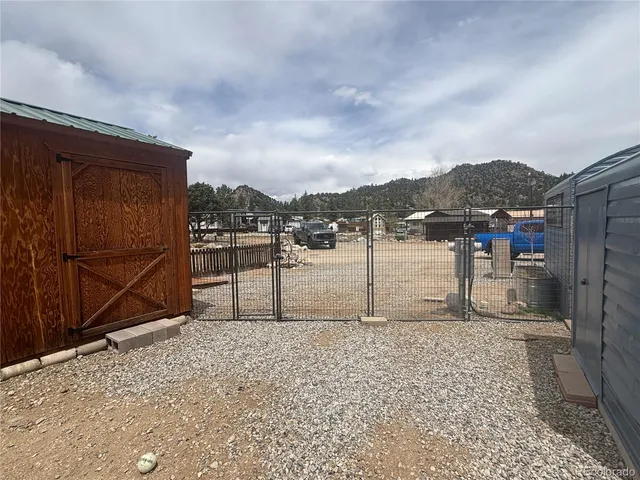 a terrace view with small garden and wooden fence