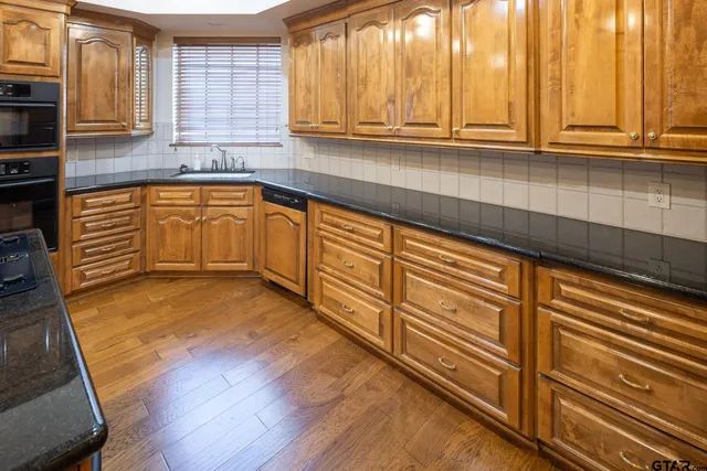 a kitchen with wooden cabinets and a sink