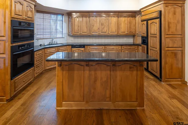a kitchen with a sink and cabinets