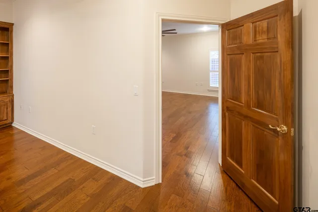 an empty room with wooden floor