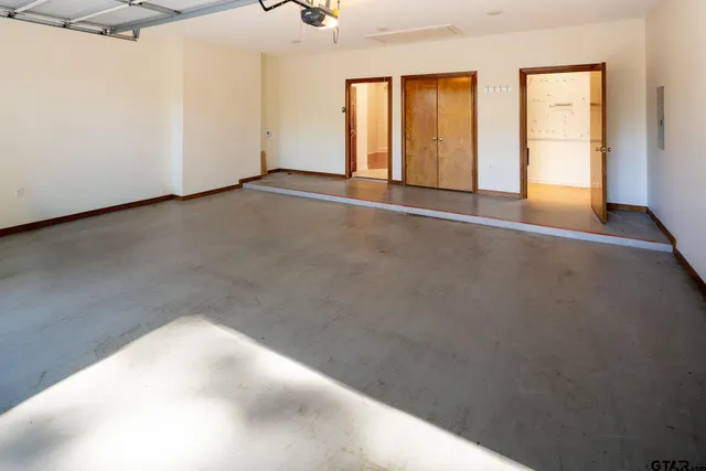 a view of a room with wooden floor and a large window