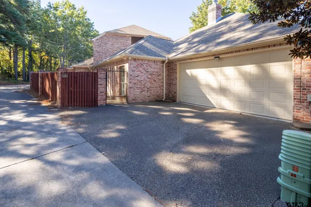 a view of a garden with wooden fence