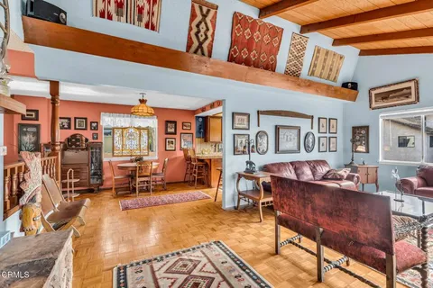 a room with gym equipment and wooden floor