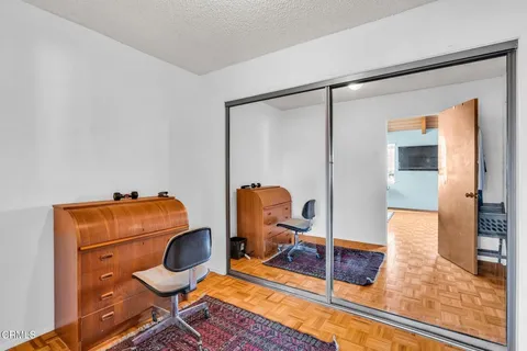 a bedroom with a bed and a large mirror