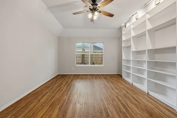 wooden floor in an empty room with a window