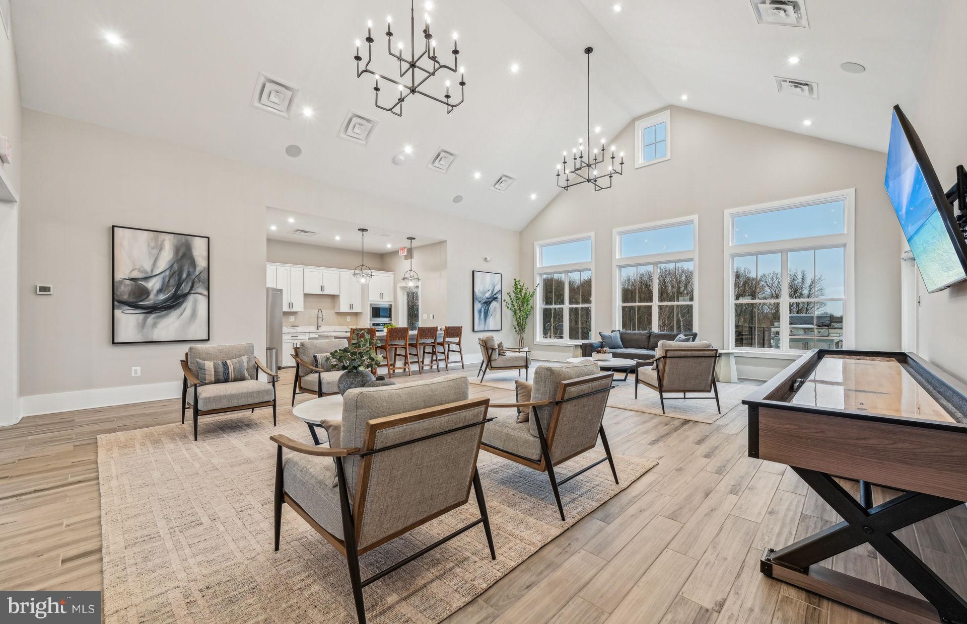 22428 Sculpin Brk Road Boyds, MD 20841 - Photo 30 of 37 a living room with furniture or couches and a dining table with wooden floor