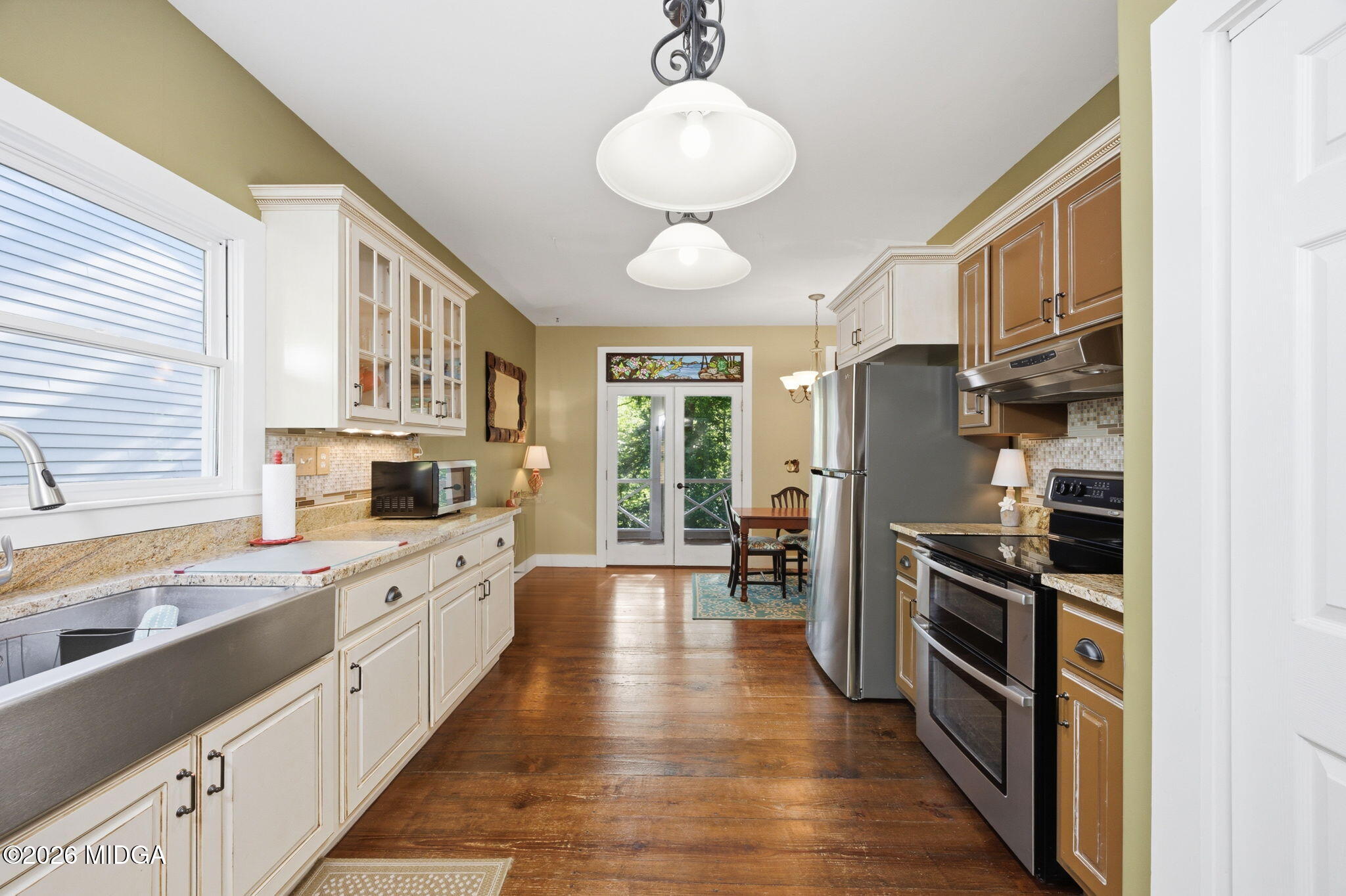 4686 Johnstonville Road Forsyth, GA 31029 - Photo 13 of 34 a kitchen with stainless steel appliances a stove cabinets and wooden floor