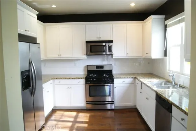 a kitchen with a sink stove and refrigerator