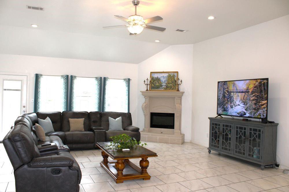 7320 County Road 3512 Quinlan, TX 75474 - Photo 11 of 35 a living room with furniture a flat screen tv and a fireplace