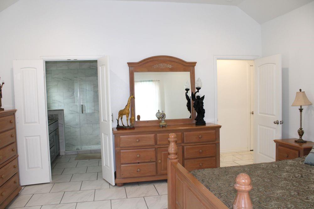 7320 County Road 3512 Quinlan, TX 75474 - Photo 19 of 35 a kitchen with a granite countertop sink and a mirror