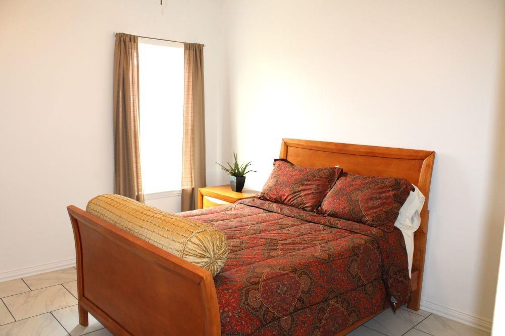 7320 County Road 3512 Quinlan, TX 75474 - Photo 23 of 35 a bed sitting in a bedroom next to a window