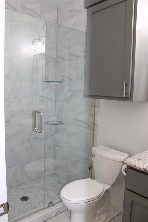 7320 County Road 3512 Quinlan, TX 75474 - Photo 24 of 35 a white toilet next to a shower