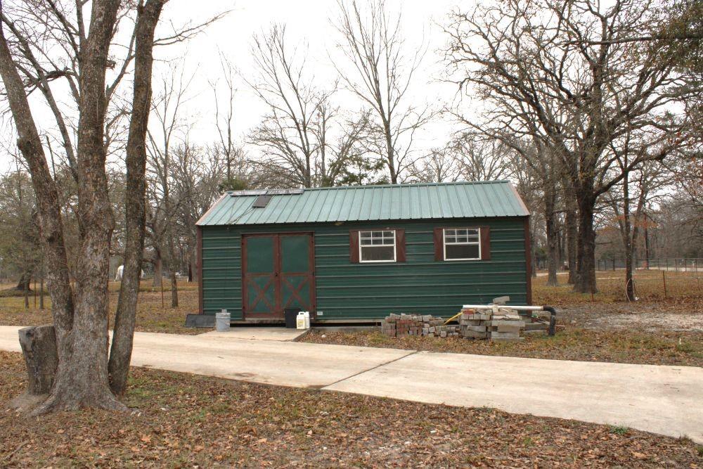 7320 County Road 3512 Quinlan, TX 75474 - Photo 28 of 35 a backyard of house with a bench and trees